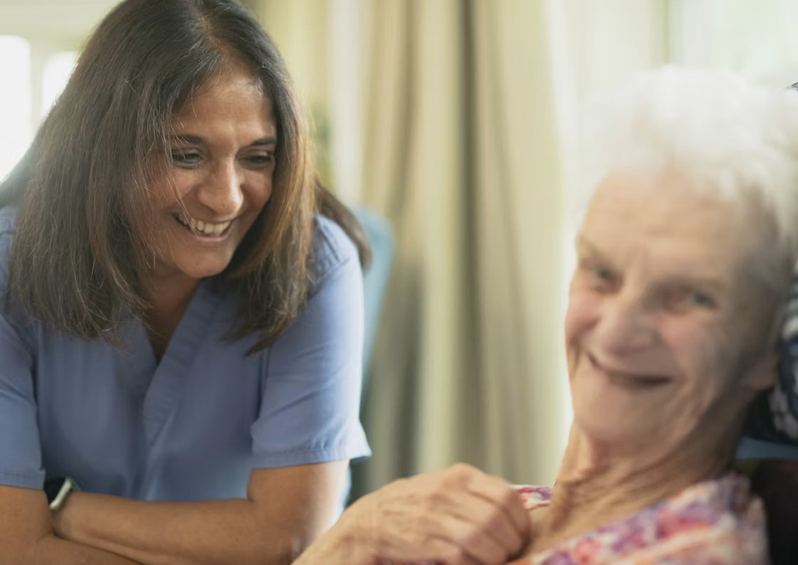 A dedicated caregiver assisting an elderly person at home